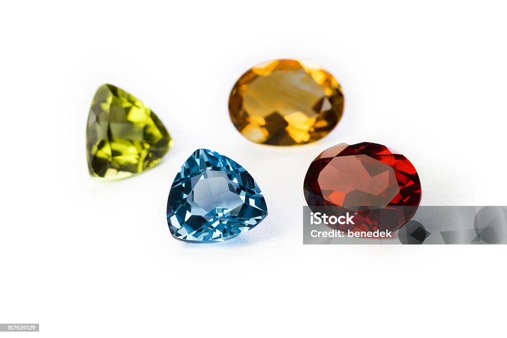 Precious Gemstones Garnet Imperial Topaz Ruby and Sapphire Closeup of precious (from top left clockwise:Garnet,Imperial Topaz,Ruby and Sapphire) gemstones on white background Gemstone Stock Photo