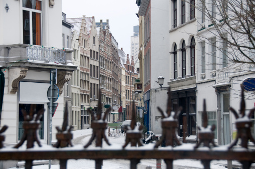 Focus on background. Nice snowy street in the Belgian city of Antwerp