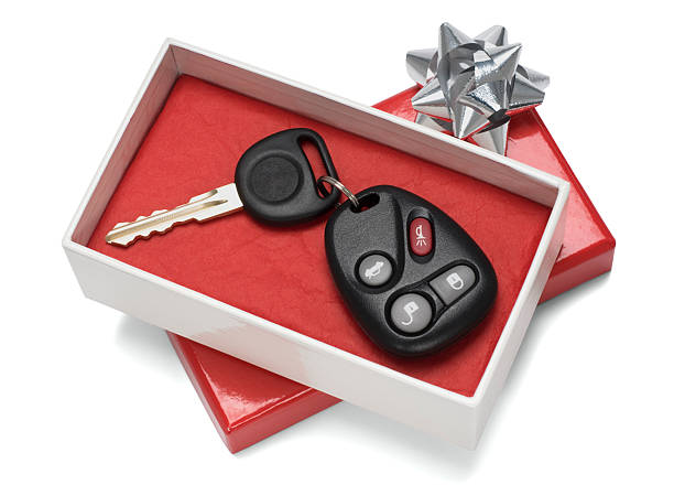 Vehicle keys in white and red gift box with silver bow stock photo