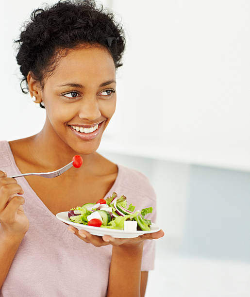 istock Happy young lady eating salad 157524825