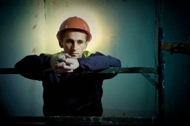 Pensive construction worker Pensive construction worker with halo of light gloriole stock pictures, royalty-free photos & images