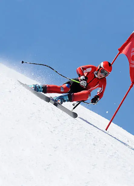 Front view of young female giat slalom competitor in the action, diagonal composition, selective focus