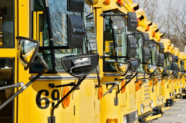 istock Row of yellow school buses 157525376