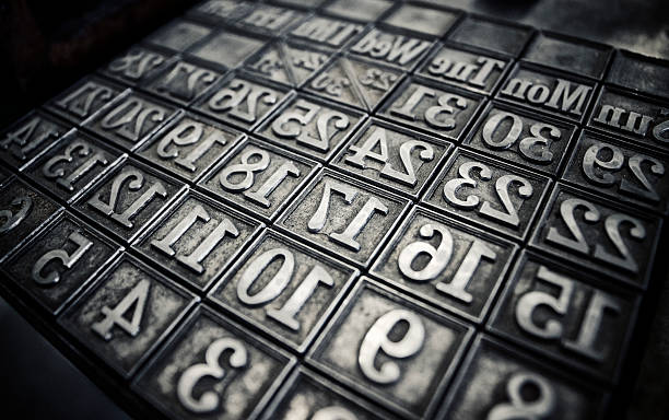 Letterpress calendar forme Calendar days and dates set up in a chase to make a letterpress printing forme. High contrast with grain and slight hint of colour.  printing plate photos stock pictures, royalty-free photos & images