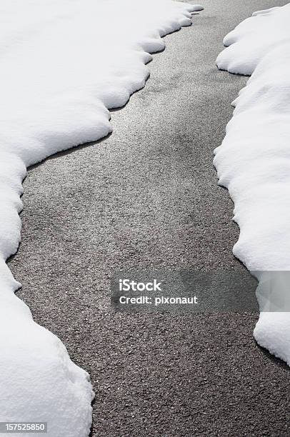 Country Road With Melting Snow On Either Side Stock Photo - Download Image Now - Snow, Melting, Heap