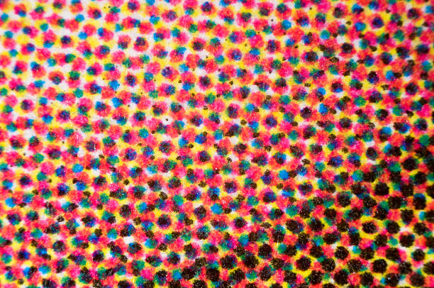 CMYK dots of four-color printing micrograph Photomicrograph of four-color printing. Individual dots of cyan, magenta, yellow, and black are visible. Dry mount, 2.5X objective, reflected illumination. cmyk stock pictures, royalty-free photos & images