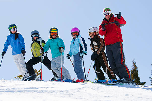 Childrens ski lessons Ski school group ski instructor stock pictures, royalty-free photos & images