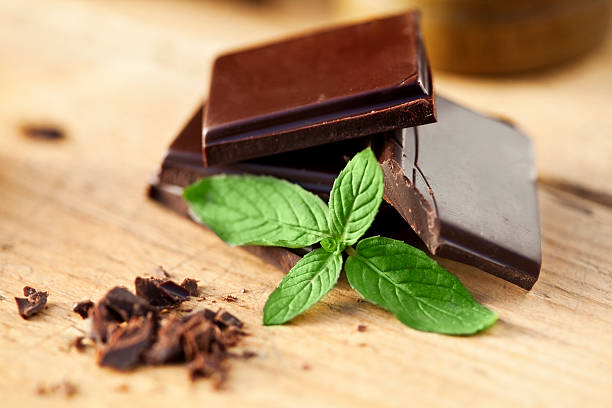 Chocolate and mint on a wooden table. Shallow depth of field.