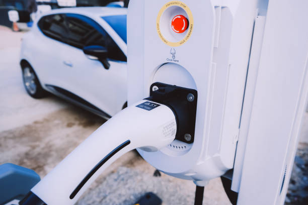 istock White charging station for electric car with the power cable. 1575265737