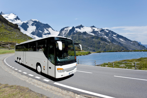 White bus crossing the alpes