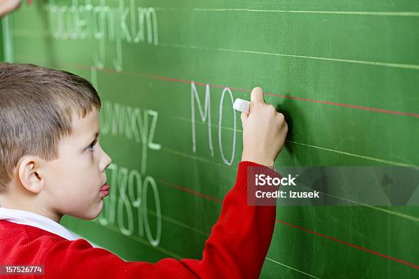 School Boy Writing On Blackboard Side View Stock Photo - Download Image Now - Boys, Child, Concentration