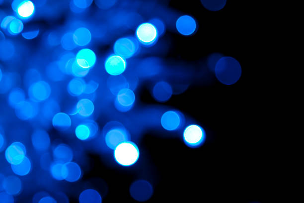 istock Soft-focus twinkling blue lights on black 157526885