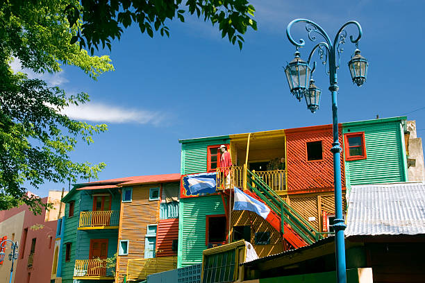El Caminito in La Boca, Buenos Aires, Argentina Colorful houses on the Caminito in La Boca, the famous artistic community of Buenos Aires, Argentina, with the Argentinean flag and a blue lamppost. la boca stock pictures, royalty-free photos & images
