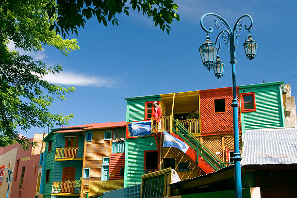 El Caminito in La Boca, Buenos Aires, Argentina Colorful houses on the Caminito in La Boca, the famous artistic community of Buenos Aires, Argentina, with the Argentinean flag and a blue lamppost. la boca buenos aires stock pictures, royalty-free photos & images