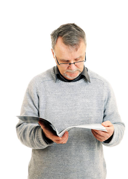 istock Senior man reading a magazine 157526905