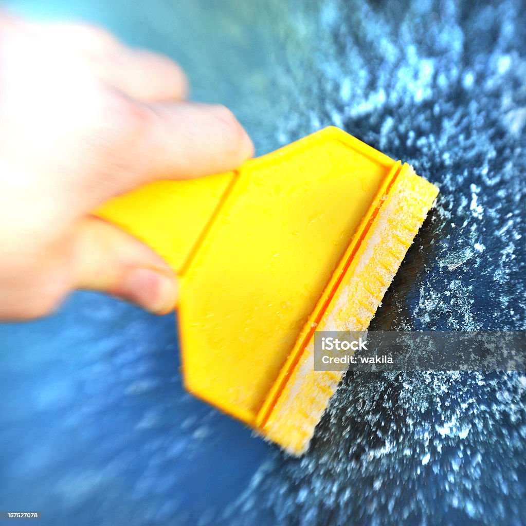 scratching ice with yellow utensil  Car Stock Photo