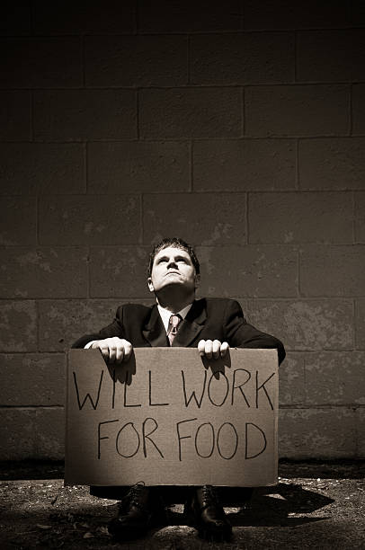 istock Unemployed Businessman Holding Will Work For Food Sign 157527157