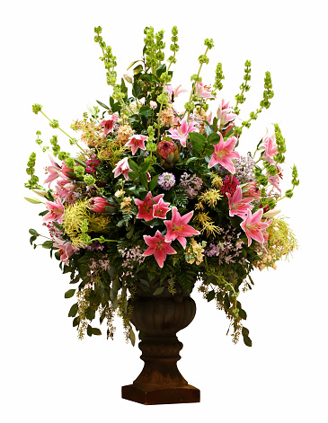 Bouquet of artificial diverse flowers Close-up in a beautiful golden vase