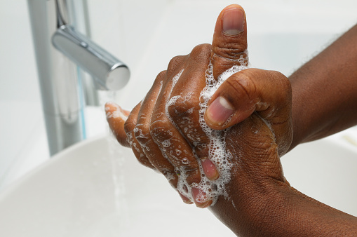 An African American hand washing.  Part of Surgical Scrub Technique for Hand Decontamination