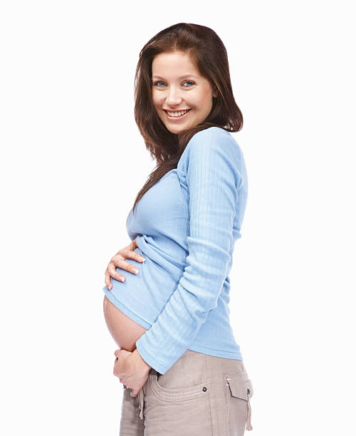 happy woman holding her pregnant belly - pregnant isolated on white stockfoto's en -beelden