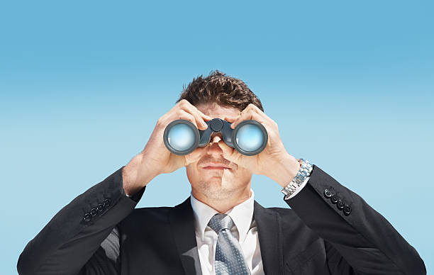istock Business man looking through a pair of binoculars 157527763