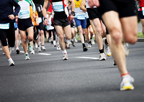 group of marathon runners on the road