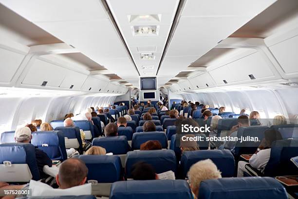 The Interior Of An Airplane With Passengers Stock Photo - Download Image Now - Airplane, Indoors, Passenger