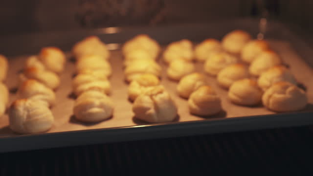 slow motion handheld shot of profiteroles in oven