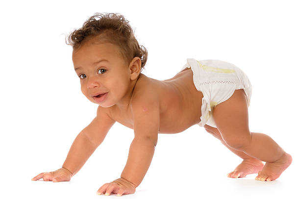 Baby Doing a Press Up Learning to Crawl A 6 month old baby learning to crawl crawling photos stock pictures, royalty-free photos & images
