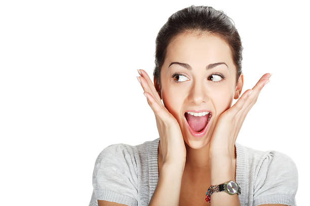 Close-up of young woman looking surprised stock photo
