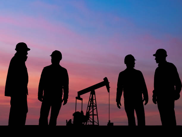 Four Oil Worker s and Pumpjack with Moody Sky  oil pump oil industry alberta equipment stock pictures, royalty-free photos & images