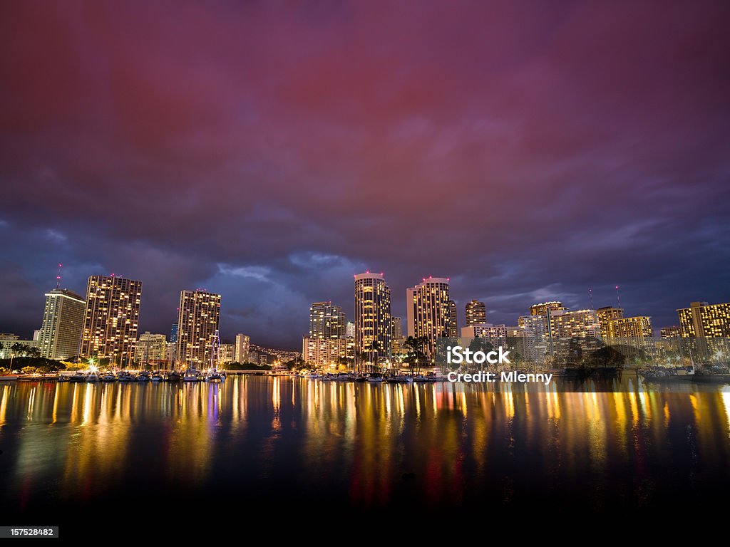 Honolulu Waikiki Harbor Skyline Night Hawaii USA Beautiful illuminated skyline of Honolulu, Waikiki Harbor with yachts, motor boats, luxury hotels and an amazing red luminous skyscape shortly after sunset. Reflections of the city light in the calm water of the yacht harbor. Honolulu, Waikiki, Oahu, Hawaii Islands. Awe Stock Photo Honolulu Waikiki Harbor Skyline Night Hawaii USA Beautiful illuminated skyline of Honolulu, Waikiki Harbor with yachts, motor boats, luxury hotels and an amazing red luminous skyscape shortly after sunset. Reflections of the city light in the calm water of the yacht harbor. Honolulu, Waikiki, Oahu, Hawaii Islands. Awe Stock Photo