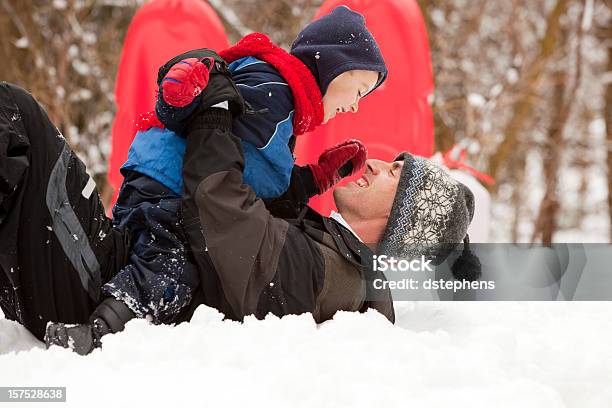 Playful Father And Son In Snow Stock Photo - Download Image Now - Family, Latin American and Hispanic Ethnicity, Winter