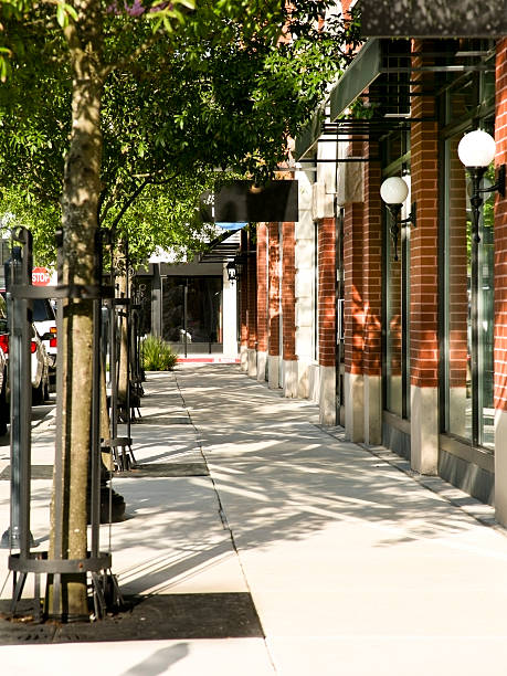 istock Tree lined sidewalk in front of main street shops. Downtown. 157528646