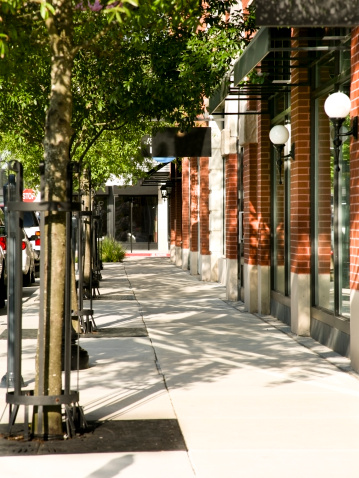 Tree lined sidewalk in front of main street shops in downtown area. Small town USA.  MORE LIKE THIS... in lightboxes below!   MORE LIKE THIS... in lightboxes below!