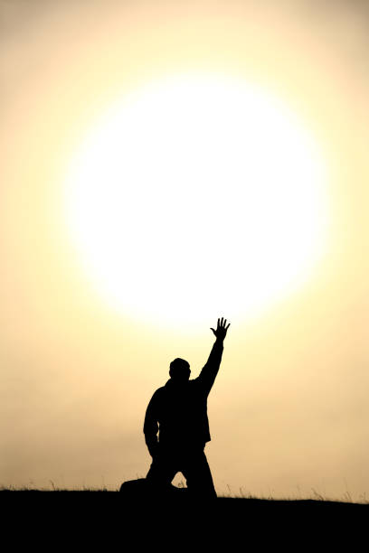istock Man Lifting His Hand In Praise and Worship 157528649