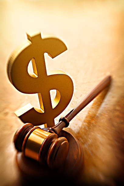Close up of businessman hand crashing dollar sign with hammer