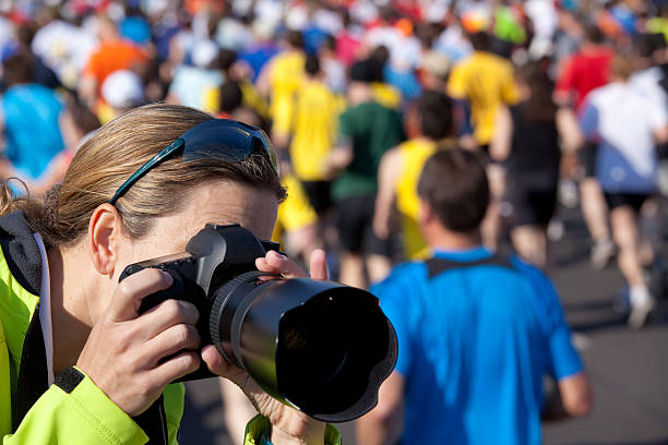 taking pictures at marathon female photographer close taking pictures at marathon sports photography stock pictures, royalty-free photos & images