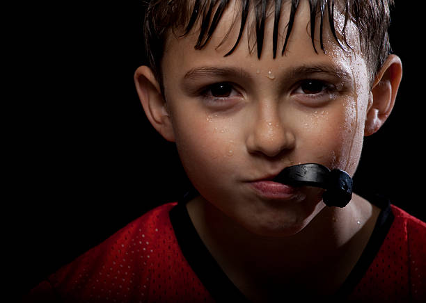 Young athlete Portrait of a young serious flag football player.  mouthguard stock pictures, royalty-free photos & images