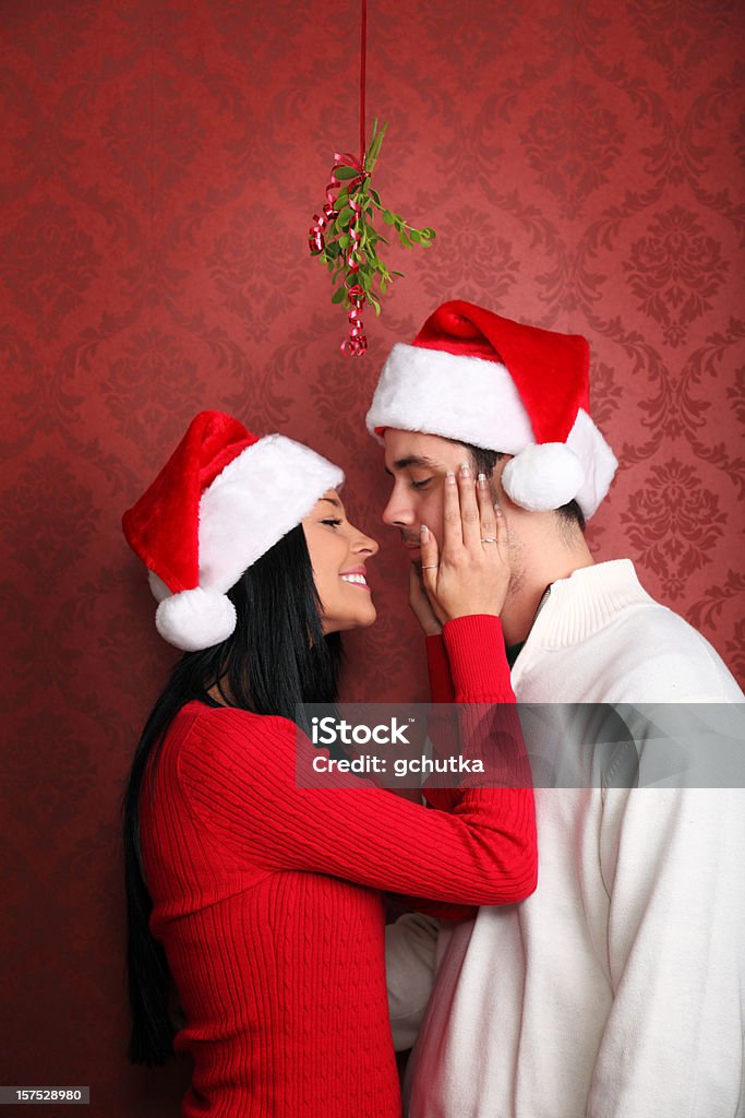 Kissing Under The Mistletoe Stock Photo - Download Image Now - Mistletoe,  Kissing, Christmas - iStock