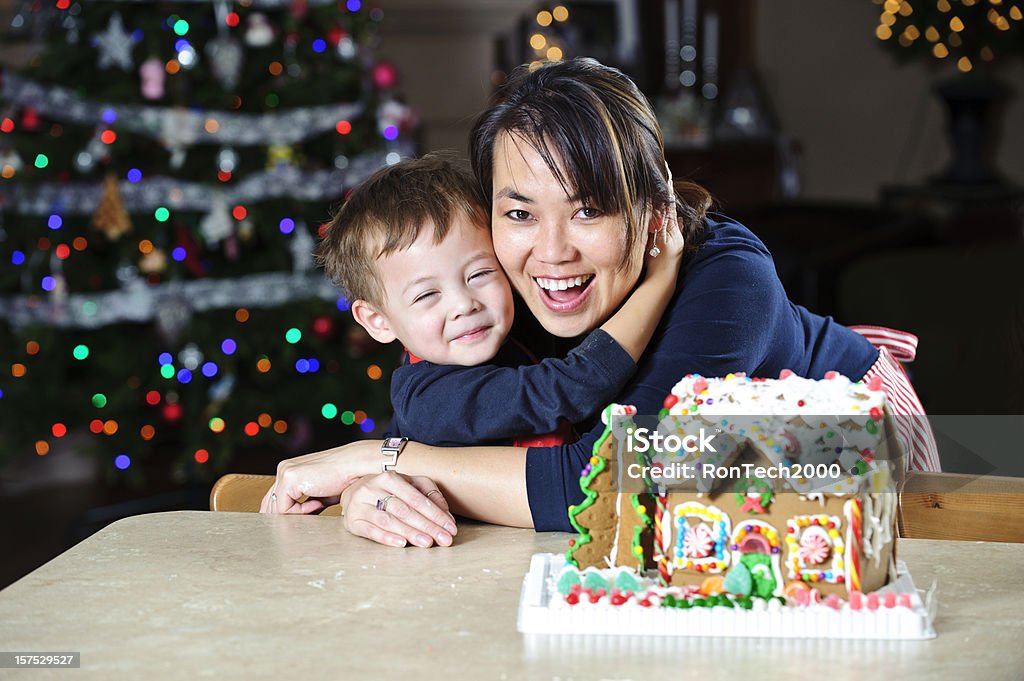 Christmas Hugs big christmas huggies / between a mother and son / 'cause they're having fun Gingerbread House Stock Photo