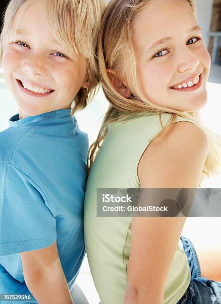 Brother And Sister Sitting Together Stock Photo - Download Image Now - 6-7 Years, 8-9 Years, Affectionate