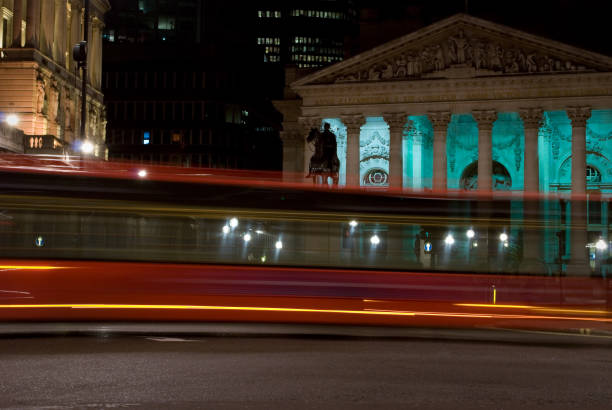 istock The Royal Exchange, London, red bus at night, motion blur 157529696