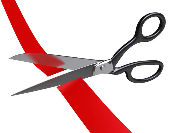 Scissors cutting Red Tape stock photo