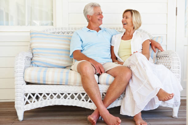 istock Elderly couple enjoying a chat on cane couch 157529784