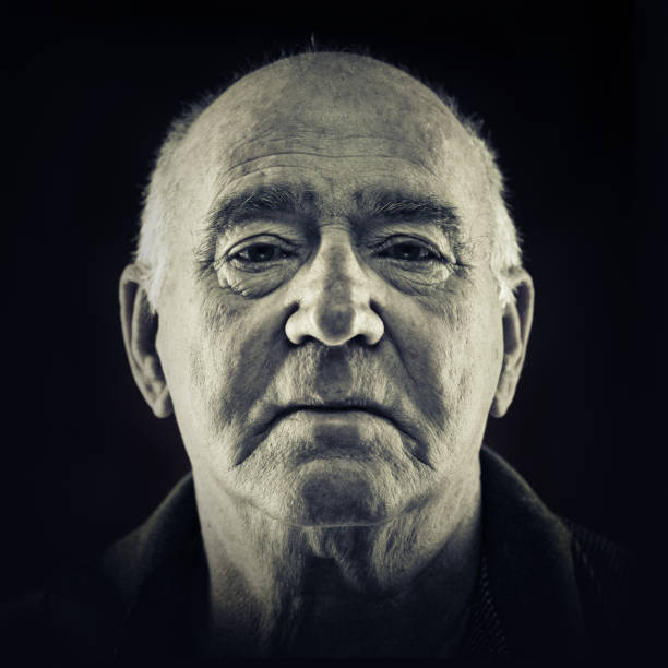 istock senior man portrait on black background 157530431