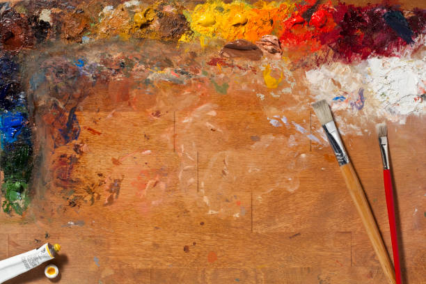 Painters Palette and Brushes. Full Frame, Horizontal. Painters Palette with paint and brushes. Big Full Frame image with a lot of Copy Space area, Horizontal. oil paint palette stock pictures, royalty-free photos & images