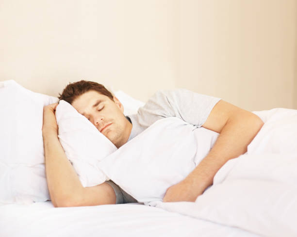 istock Mid adult man fast asleep in bed 157530493