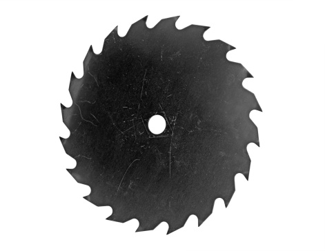 A used circular saw blade with a clipping path. This image is in black and white.