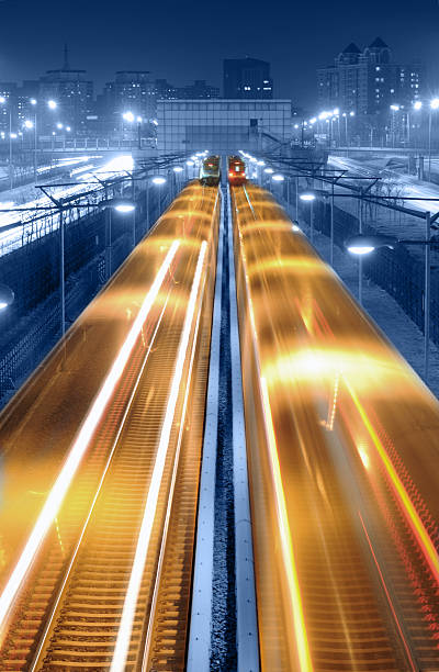 Modern Transportation - XLarge Long exposure photography of high speed train traffic through city at night scene paris metro sign stock pictures, royalty-free photos & images